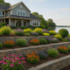 Lakeshore tiered retaining wall with flowering plants and ornamental grasses.