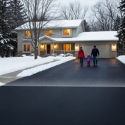 Minnesota heated driveway in winter, snow-free while family walks safely and car backs out, surrounded by snow-covered yard.