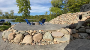 Boulder Retaining wall with stone patio